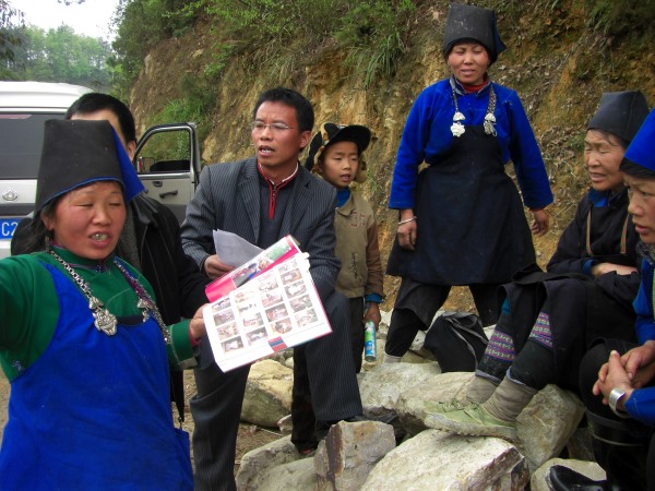 Woman holding an open book amongst a group of people