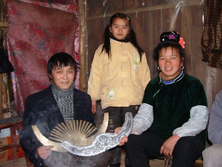 Smiling young Chinese girl wearing a traditional hat